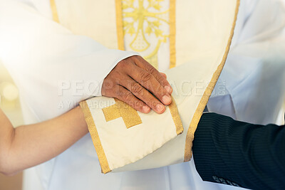 Hands, priest and couple while praying, wedding and commitment in church for marriage blessing. Christian pastor prayer for man and woman in ceremony, spiritual and religion event in a service