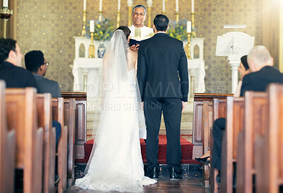 Buy stock photo Wedding, priest and couple at the altar for marriage vows in commitment ceremony in a church from behind. Married, love and caring bride and groom celebrating their loving relationship in a chapel