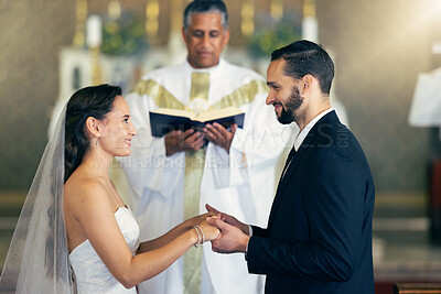 Buy stock photo Couple getting married, wedding vows and love commitment at the alter of church during marriage ceremony. Happy bride, groom and Christian priest performing rites, religious and spiritual connection 