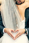 Hand, heart and bride and groom hug at their wedding, happy and relax while sharing an intimate moment. Hands, love and couple celebrate their marriage, embrace and having fun while showing emoji