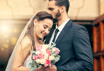 Buy stock photo Marriage love, flower bouquet and wedding couple kiss after partnership commitment, floral trust ceremony and unity event. Romantic flare, church and christian bride and groom happy with holy union