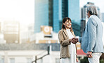 Business people, handshake and partnership deal in the city for agreement, trust or b2b in the outdoors. Woman and man shaking hands for greeting, business proposal or meeting idea for collaboration