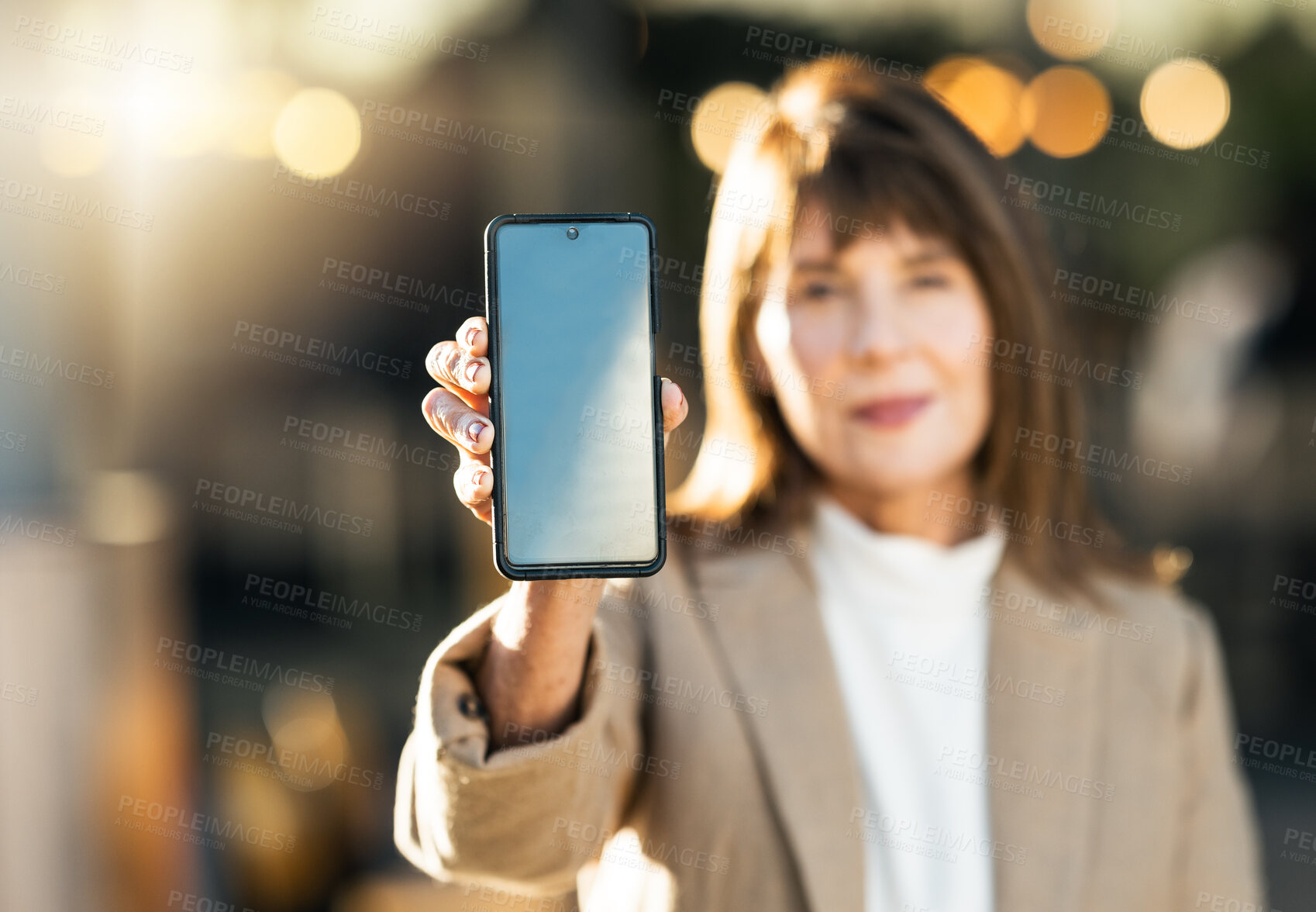 Buy stock photo Woman, hand and phone mockup on bokeh background for mobile advertising, marketing or sale in the outdoors. Hands of female showing wireless technology smartphone for communication on blue chromakey