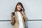 Phone call, coffee and city with a business woman talking on a mobile while leaning against a concrete wall outdoor. Smartphone, communication and networking with a female employee chatting in town