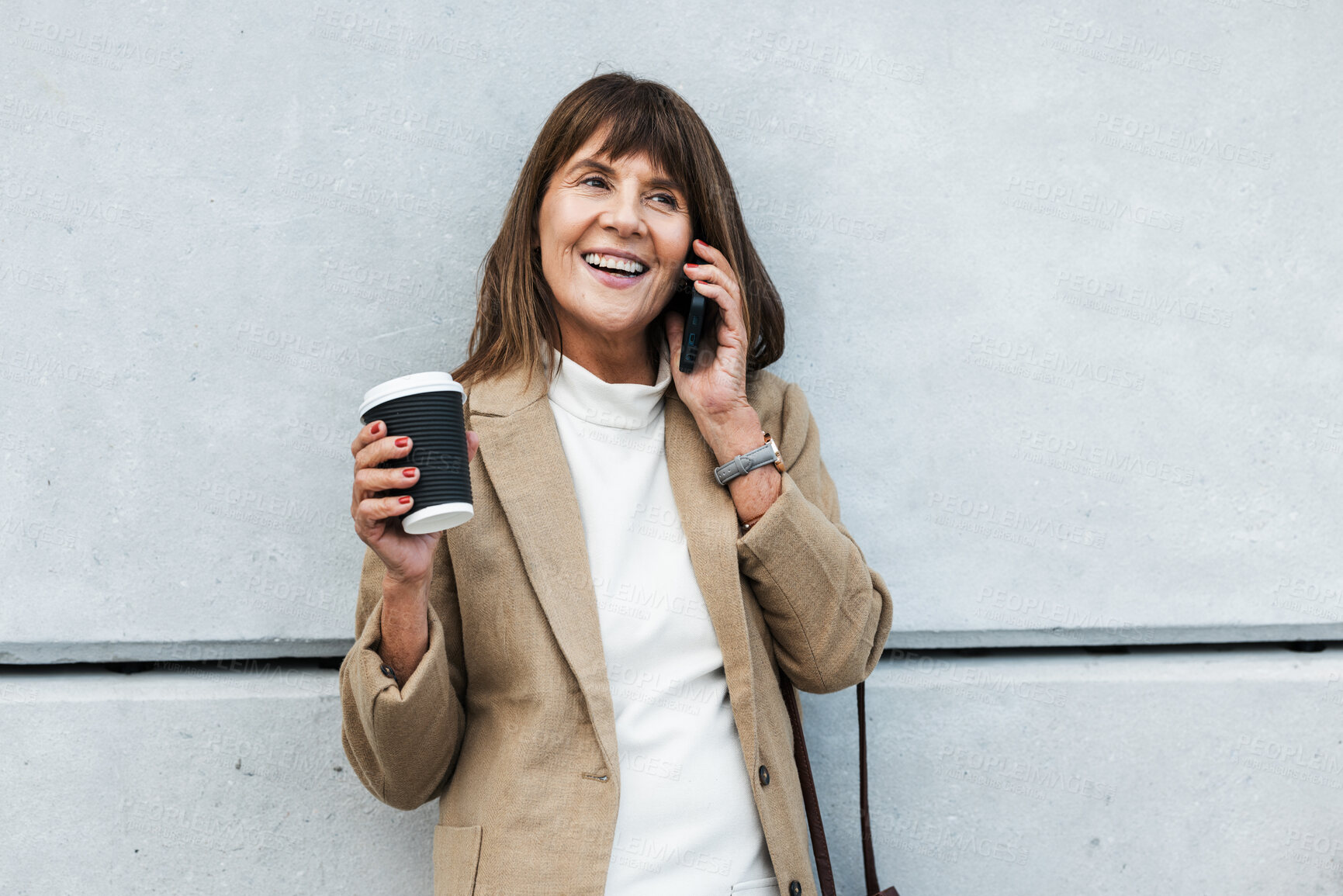 Buy stock photo Phone call, coffee and city with a business woman talking on a mobile while leaning against a concrete wall outdoor. Smartphone, communication and networking with a female employee chatting in town