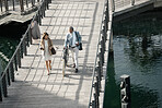 Walking, bicycle and team of business people talking, conversation or speaking while travel on river lake bridge. Journey, eco friendly transportation and cycling man and senior woman commute to work