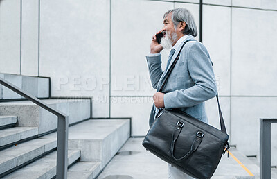 Buy stock photo Phone call, communication and mature businessman talking, networking and planning on a phone walking to work. Smile, corporate and manager speaking on a mobile on a walk on stairs in the city