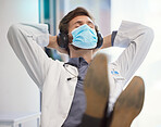 Doctor, covid face mask and relax in healthcare hospital with headphones to listen to music after finished task, job or pandemic. Medical worker man at work during covid 19 for safety and care