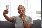 Black woman, peace sign or phone selfie on house sofa, home or hotel living room for social media, online dating app or profile picture. Smile, happy or relax person on mobile photography technology