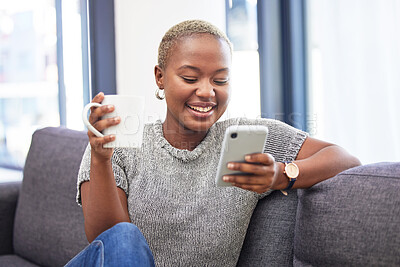 Buy stock photo Woman, phone and relax on sofa with coffee for morning routine scroll social media. Happy African girl, streaming on smartphone and read digital 5g communication on couch with tea in living room