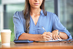 Business woman, accountant and notebook while writing notes and using calculation for budget, profit and bookkeeping while sitting at a desk. Hands of entrepreneur with planner for financial report