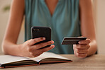 Woman, hands and phone in ecommerce with credit card for online purchase, transaction or shopping at home. Female hand holding smartphone and card for internet banking app or online shopping indoors