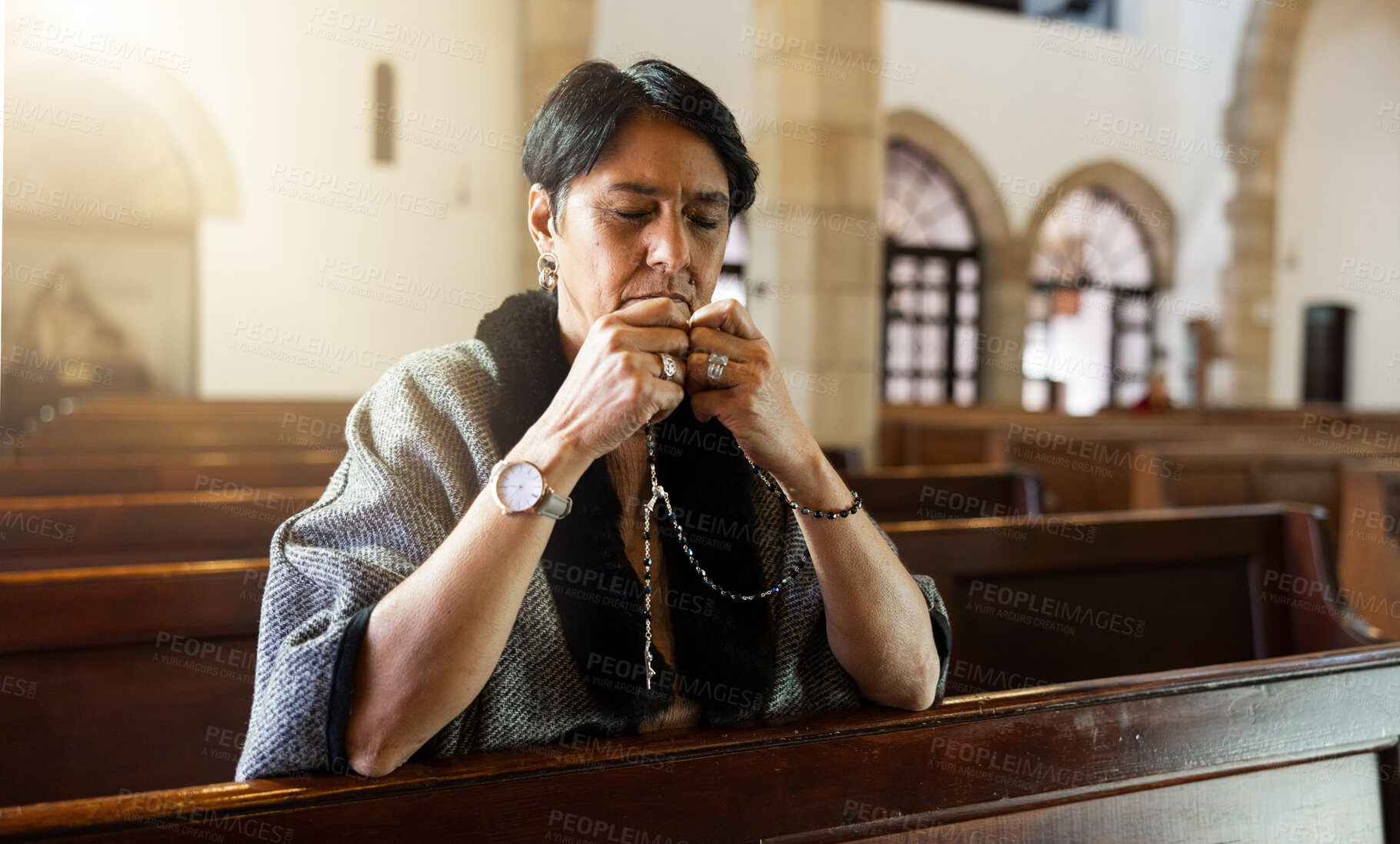 Buy stock photo Faith, senior woman and in church with rosary for prayer, worship God and religion. Religious, spiritual and elderly female in temple or sanctuary for praying, blessing or guidance with peace or calm