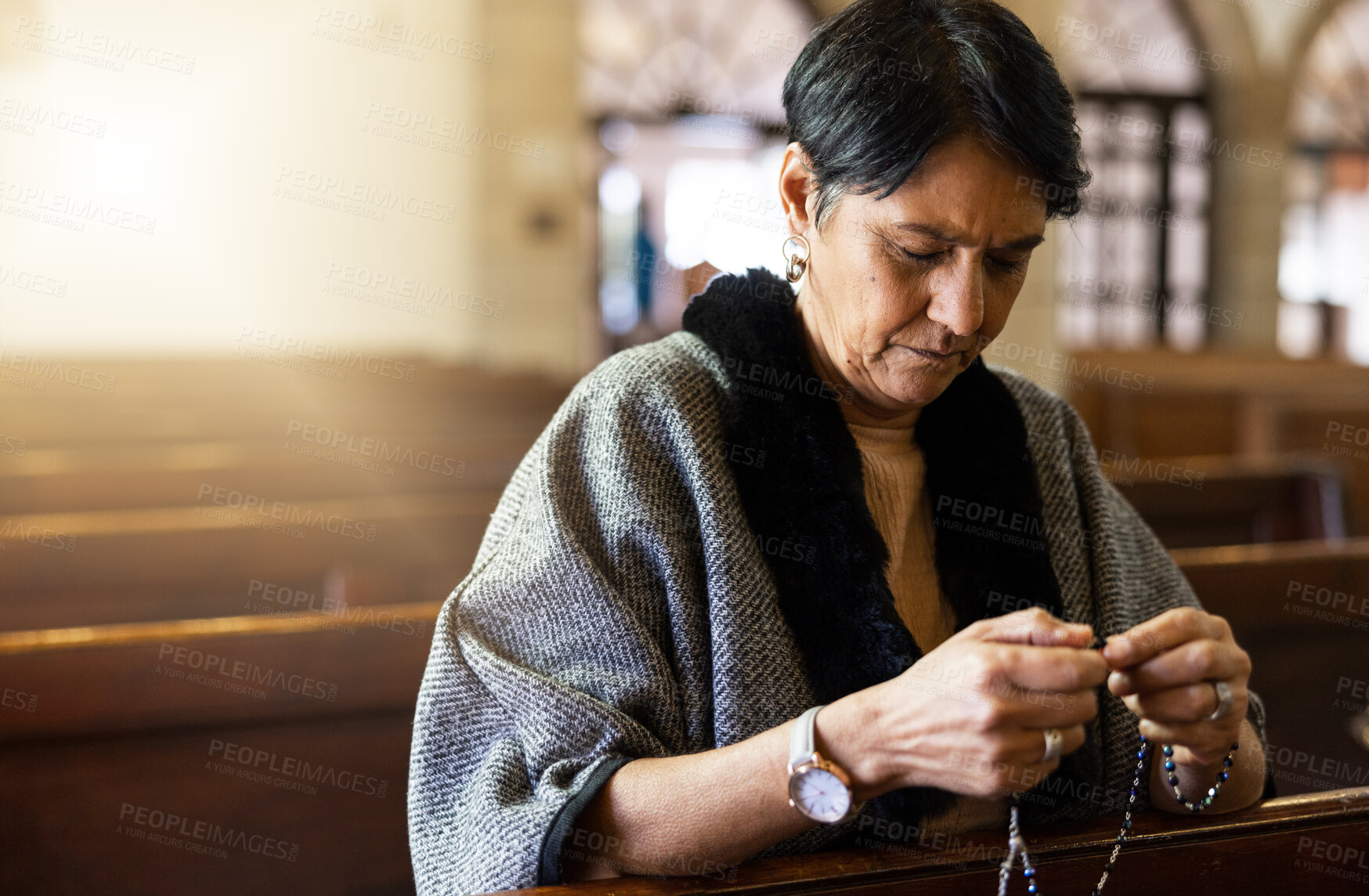 Buy stock photo Pray, senior woman and praying in church with a rosary for religion, worship and God praise, peaceful and calm. Holy, peace and prayer by Mexican female in chapel in Mexico for spiritual blessing