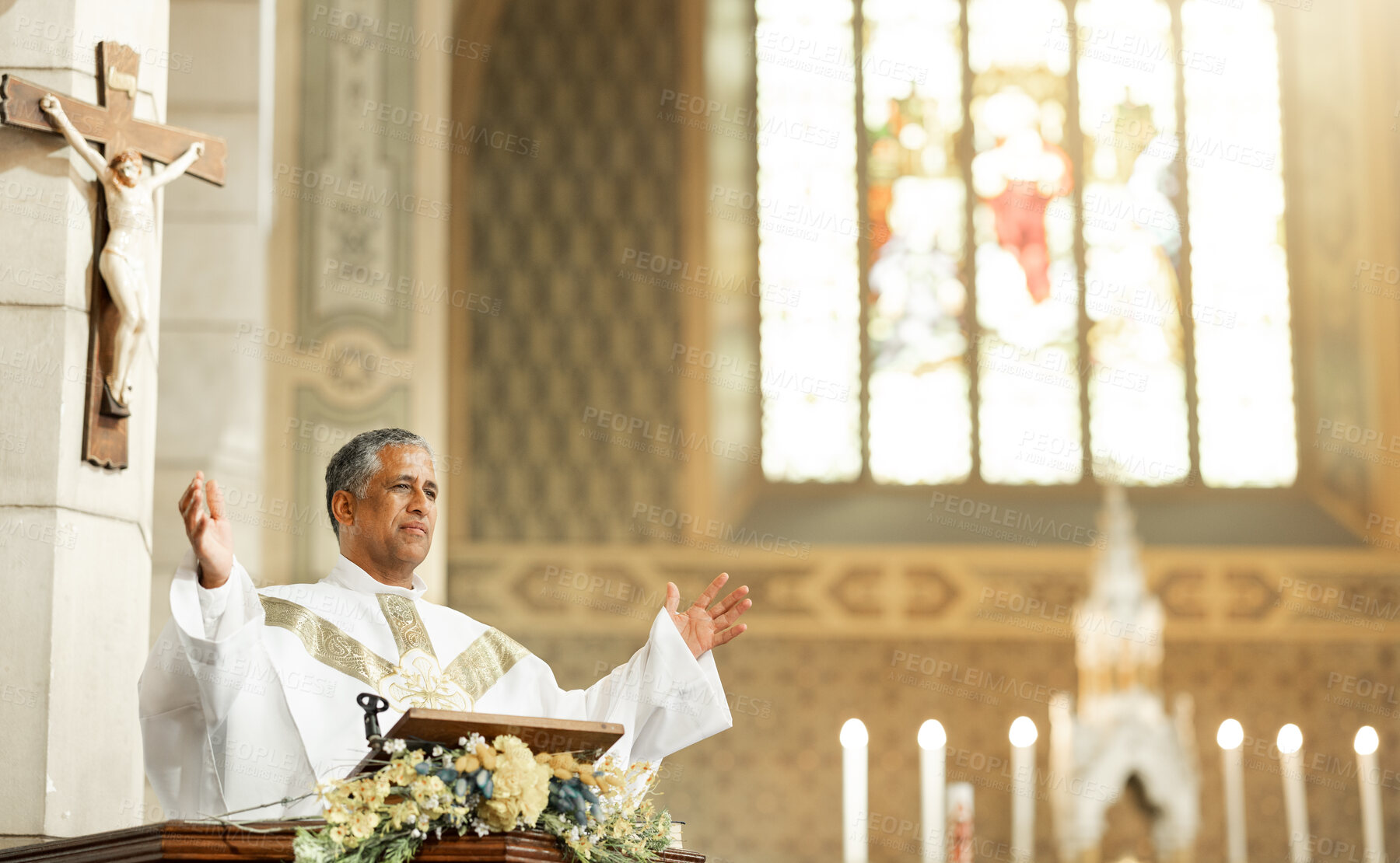 Buy stock photo Religion, Christianity and priest speaking in church with arms raised standing by podium. Ceremony, mass and religious leader in worship, preaching and prayer for congregation in spiritual building