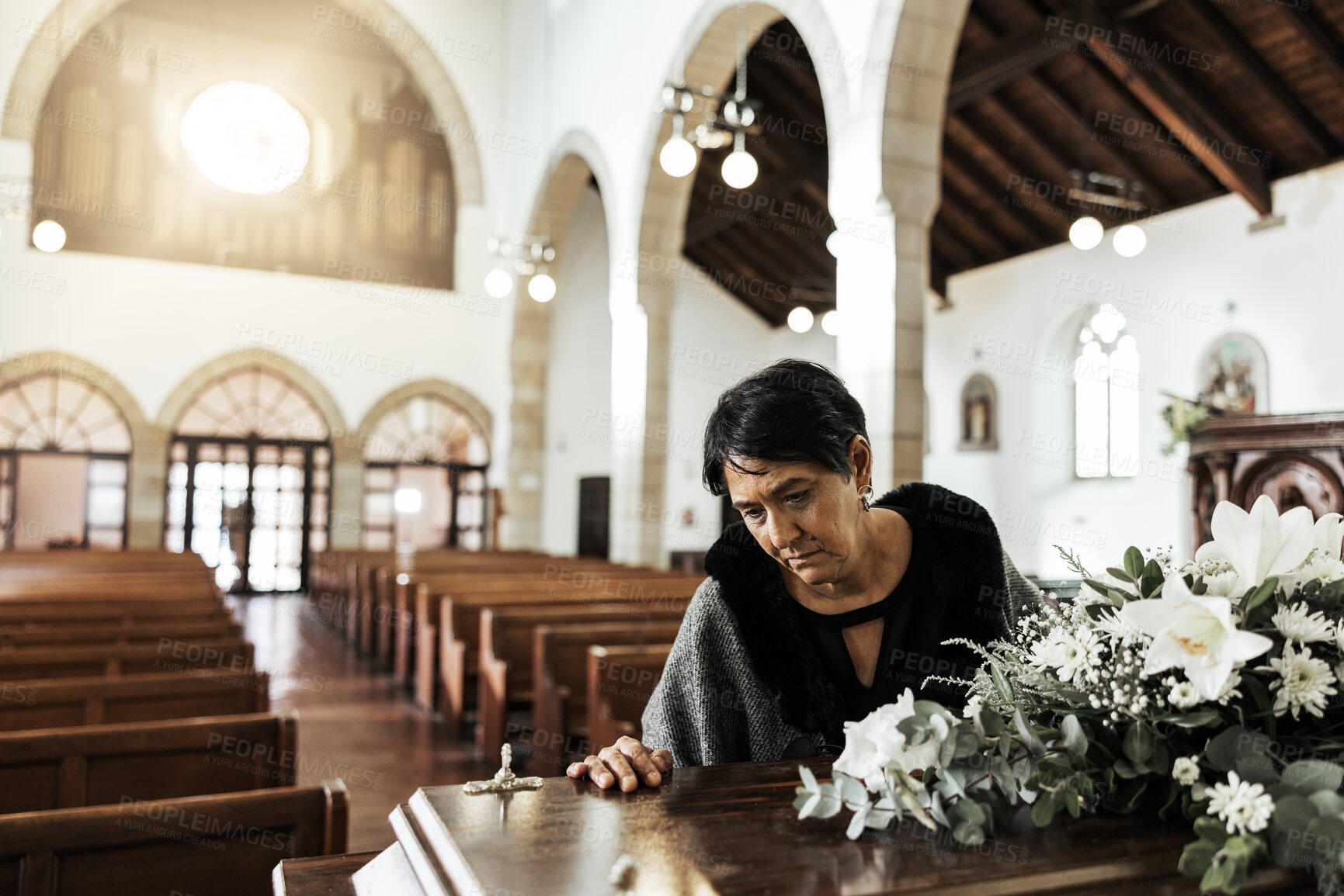 Buy stock photo Widow, coffin and sad at a funeral feeling depression from death sitting in a church. Depressed Indian woman with mourning, grief and mental health problem at an emotional religion burial event 