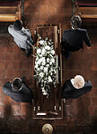 Funeral, family coffin and church above for death, grief or burial service with solidarity. Group, pallbearers and people together with casket for respect, farewell or sad in mourning, mass or loss