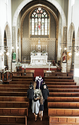 Buy stock photo Funeral, church and people walking together to carry a coffin after a death or loss while inside for memorial service. Family, friends or community feeling sad, grief and mourning at Christian event