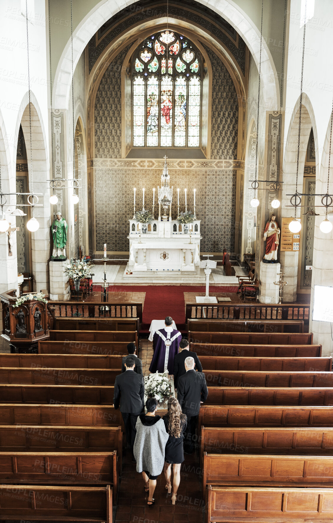 Buy stock photo Funeral, church and people walking together to carry a coffin after a death or loss while inside for memorial service. Family, friends or community feeling sad, grief and mourning at Christian event