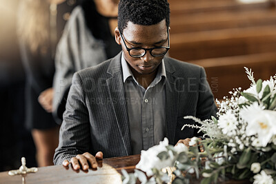 Buy stock photo Funeral coffin, death and black man sad, grieving and mourning loss of family, friends or dead loved one. Church service, floral flowers and person with casket, grief and sadness over loss of life