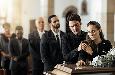 Buy stock photo Death, funeral and family touching coffin in a church, sad and unhappy while gathering to say farewell. Church service casket and sad man and woman looking upset while greeting, goodbye and rip