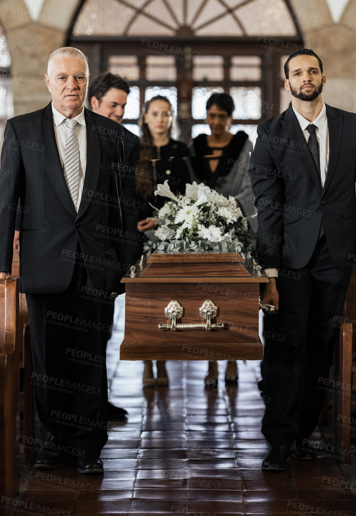 Buy stock photo Funeral, church and family carry coffin for death, grief or sermon for burial with support. People, pallbearers and sad together with casket for respect, farewell or sorrow in mourning, mass or loss