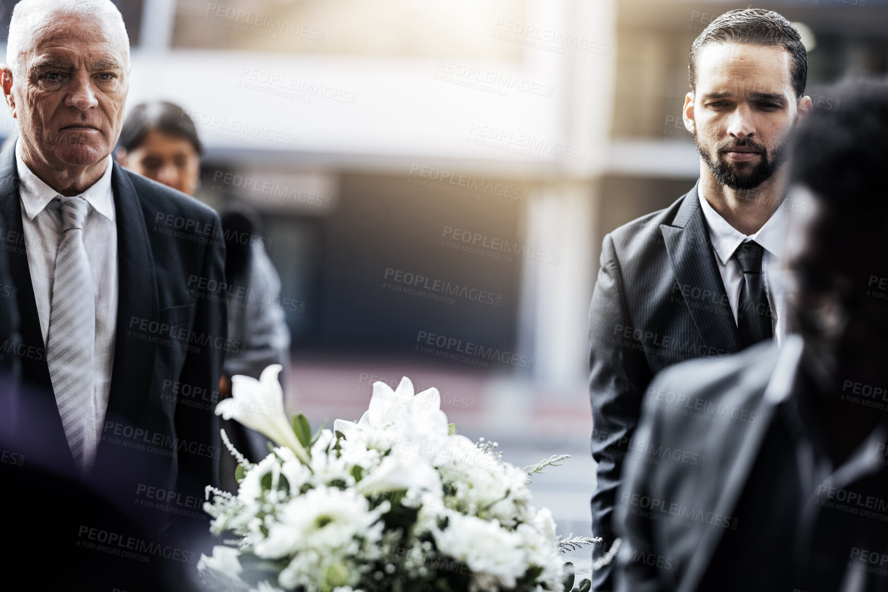 Buy stock photo Man, funeral and carrying coffin in grief for loss, death or sorrow walking to the cemetery or burial. Group of mourning men lifting casket together of the deceased for ceremony, church or graveyard