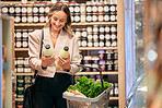 Woman, shopping and organic milk for diet, health or nutrition in store, supermarket or grocery shop. Happy, vegan girl and sale of product in retail, discount or promotion  sales for wellness food