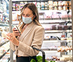 Grocery store, woman and phone food ingredient check of a retail customer shopping in a supermarket. Groceries shop of a person looking at a mobile app for a healthy recipe with a covid mask