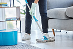 Mop, flooring and woman cleaning living room house, home and apartment. Cleaner, maid and housekeeping service on wet ground, care and safety of virus, bacteria and dust for household disinfection 