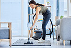 Smile, vacuum machine and woman cleaning the floor in the living room in home. Happy latino cleaner doing housework, housekeeper or job in a clean lounge, hotel room or house while spring cleaning