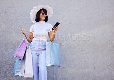 Buy stock photo Shopping, phone and woman in the city for fashion sale, discount and fun against a wall background mockup. Girl, shopping bag and online search on social media for promo code, retail news and mock up