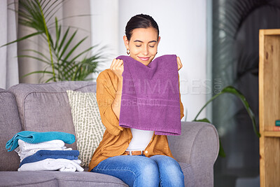 Buy stock photo Woman, cleaning and smell towel, fresh and clean laundry in home with happy smile. Content female relax and smelling the scent of washing, happiness and fragrance of material and fabric in home 