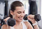 Fitness, weightlifting and smile with woman in gym for training, workout and health. Sports, exercise, and wellness with girl athlete and dumbbells for endurance, strength and bodybuilder energy