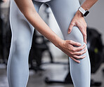 Hand, leg pain and woman at the gym in fitness fail, muscle training mistake or joint discomfort. Sports woman, knee pain and girl suffering from arthritis, inflammation or bruise during workout