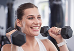 Fitness, exercise and woman with dumbbell in the gym doing workout, training and weight lifting. Health, wellness and happy female exercising with equipment in sports center with smile on face