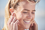 Face, happy and music with a woman listening to audio through earphones outdoor during the day. Podcast, head and closeup with an attractive young female streaming the radio while standing outside
