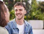 Happy man, smile and face of gay, homosexual or lgbtq guy sitting outdoor on a date while having a conversation about happiness, lifestyle and love. Gen z male in nature while talking to partner