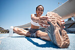 Runner, stretch and woman athlete with a smile ready for running, training and sports workout. Happy, wellness and fitness of a person stretching legs on the ground outdoor for marathon or exercise