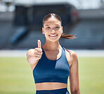 Thumbs up, woman athlete and portrait on stadium, running track and sports goals, support and competition winner. Happy young runner with motivation for winning, training and  success in arena race 