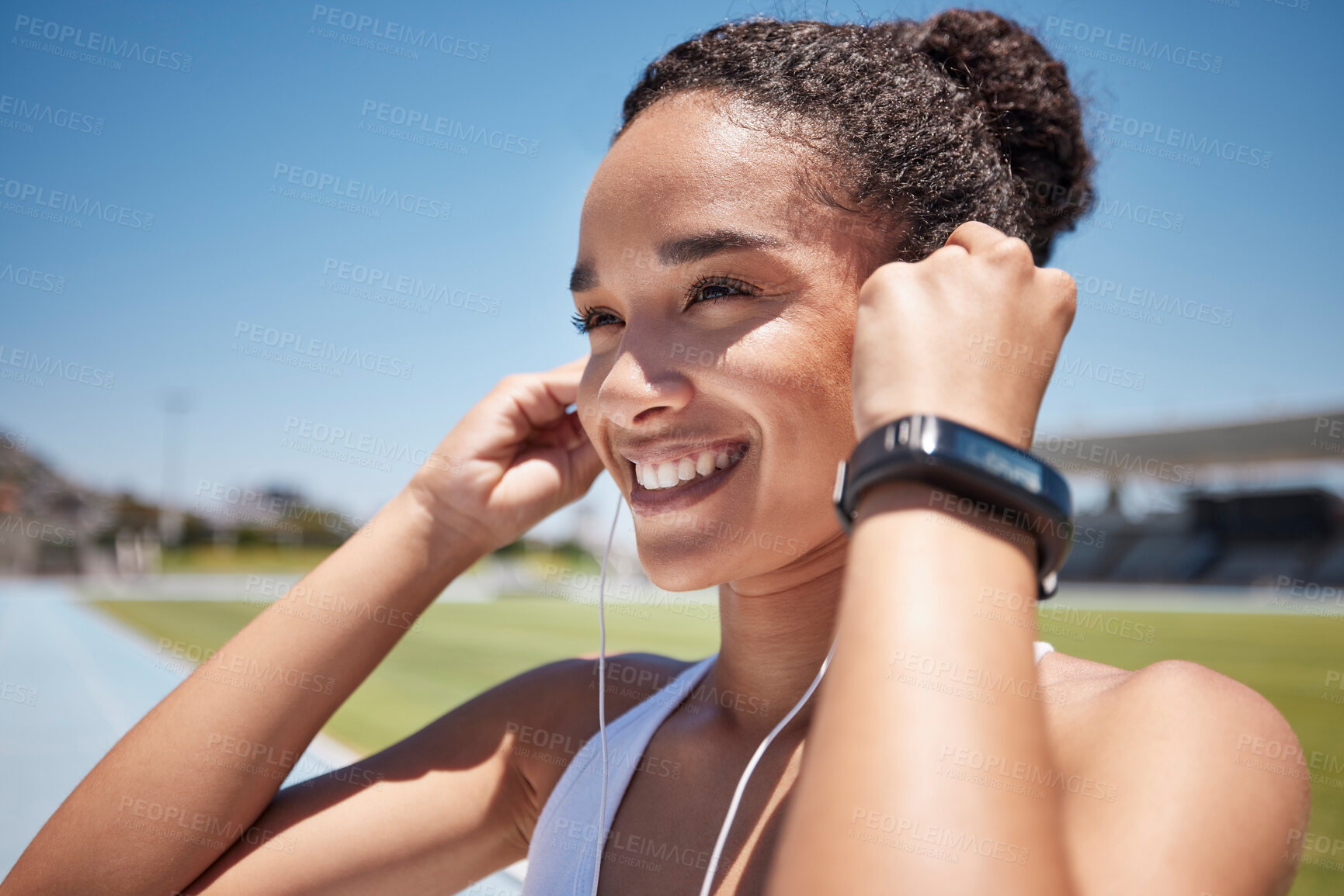 Buy stock photo Face, music and fitness with a black woman runner or athlete listening to audio during endurance training. Workout, earbuds and exercise with a female getting ready for a run on a sports track