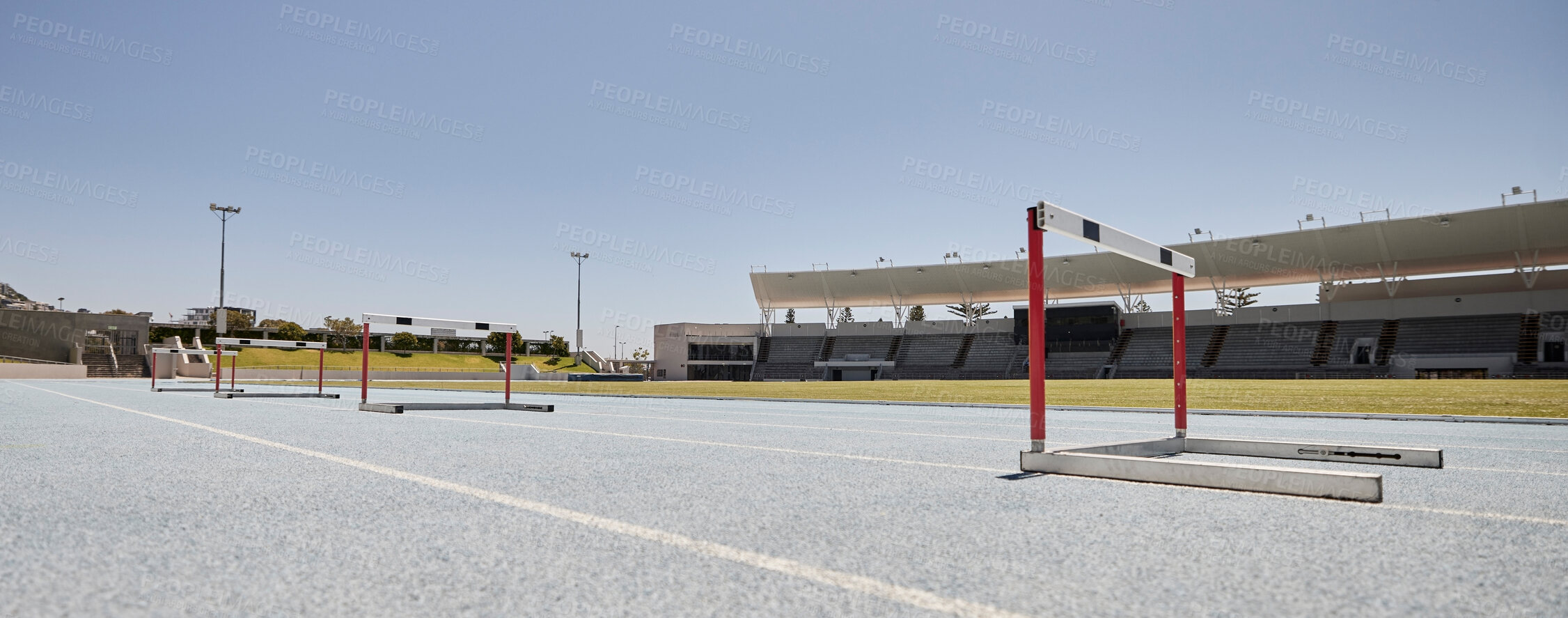 Buy stock photo Stadium, hurdles and sports event for exercise, olympics and training with no people, space and mockup. Sport, venue and hurdling workout at an empty track for workout, healthy lifestyle and venue 