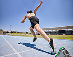 Woman track runner, running and sprint training for race exercise, fitness workout and using starting blocks for speed. Competitive sports athlete, fast track sprinter and girl exercising for cardio 