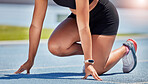 Athlete, starting line and sports track with runner outdoor for fitness, exercise and training for a race, marathon or competition. Closeup of woman runner ready to run for speed, energy and workout