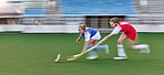 Hockey, action and running women in a game, competition or sports event for goal with speed, energy and motivation challenge. Stadium, turf field and athlete people run together with stick and a ball
