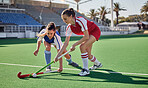 Sports fitness, field hockey game and women challenge for ball in stadium competition, club rival match or tournament contest. Training exercise, workout and athlete battle action on arena turf pitch