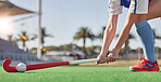 Hockey, sports and woman athlete on a turf field with a stick and ball for exercise, training and competition performance to win. Hands of hockey player on grass for sport goal, fitness and health