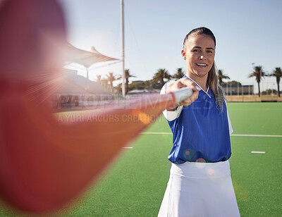 Buy stock photo Woman hockey player, closeup and portrait on field with smile, hockey stick and happy in sunshine. Hockey, outdoor and sport girl at training, exercise and workout in sports ground, arena or stadium