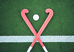 Turf field, hockey stick or sports ball on the ground for fitness competition, exercise contest or practice match. Green pitch, astroturf or cross of game equipment on the floor for training top view