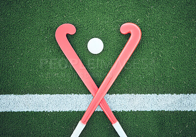 Turf field, hockey stick or sports ball on the ground for fitness competition, exercise contest or practice match. Green pitch, astroturf or cross of game equipment on the floor for training top view